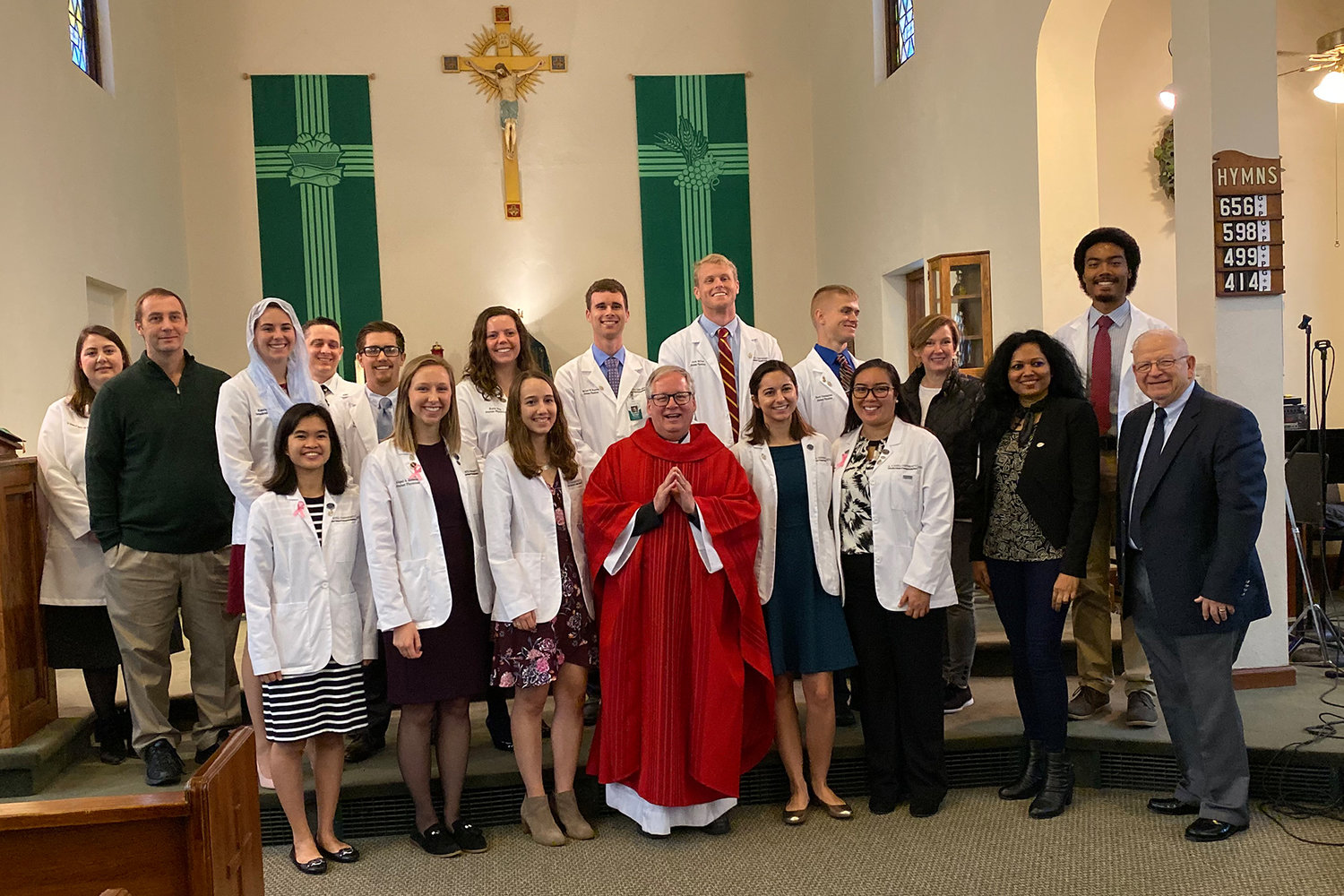 Members of the Catholic Student Association at A.T. Still University of Health Sciences and of Mary Immaculate parish in Kirksville join Monsignor David Cox, pastor, in a group photo after the inaugural White Mass for medical professionals to be celebrated in Kirksville.